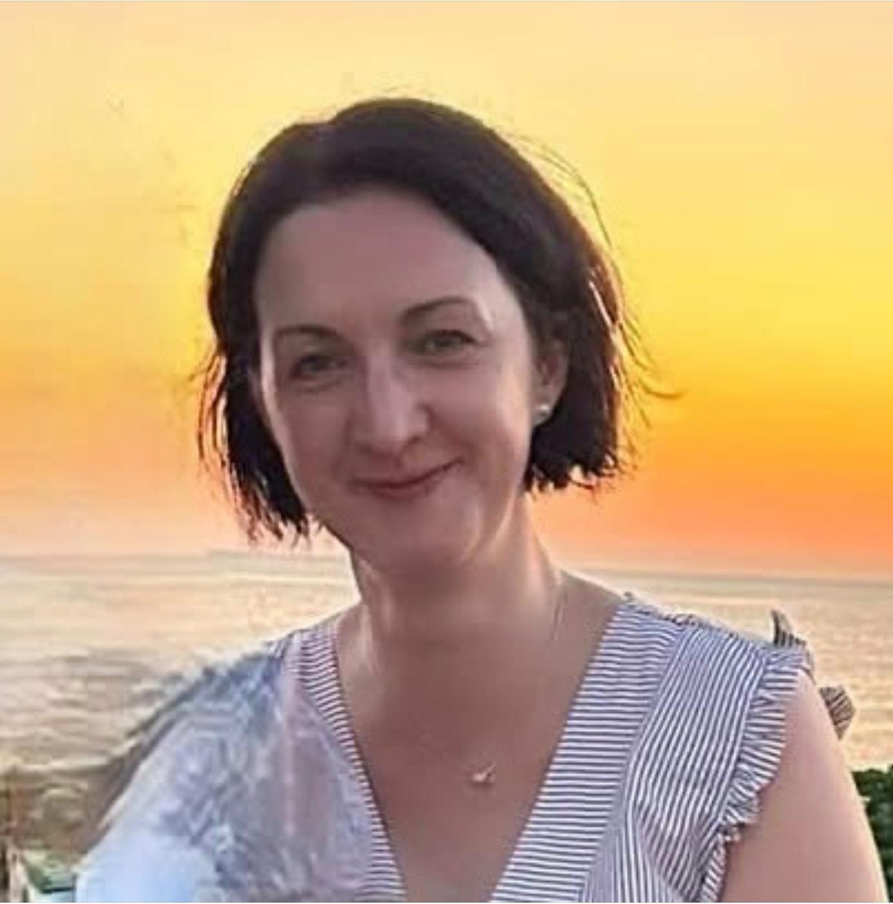 Emese Burnip, SEN travel specialist, photographed at sunset by the sea